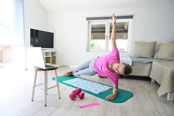 Person practicing gentle yoga on a mat in a bright room